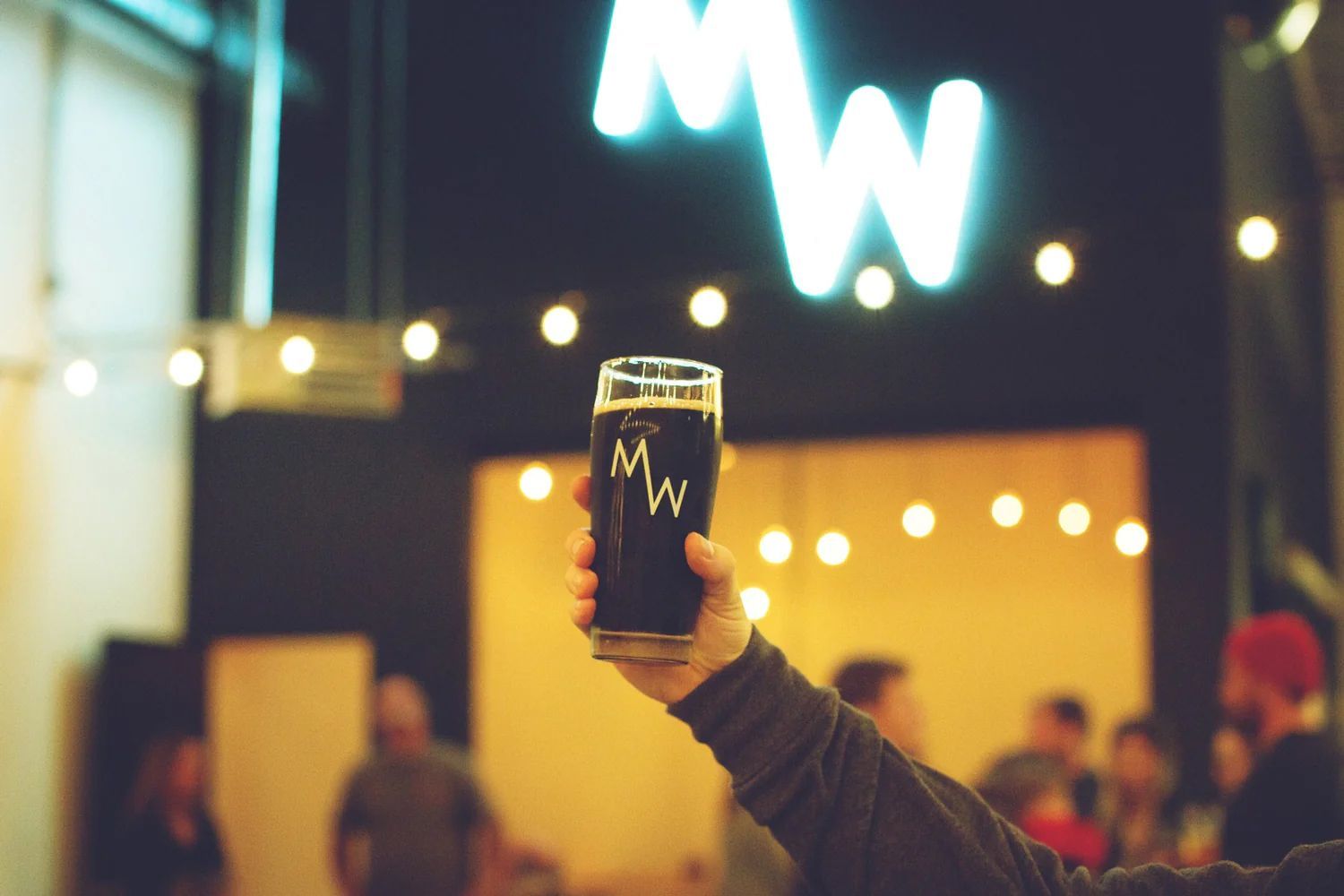 MadeWest Brewing Company - Shot inside the brewery with cup raised