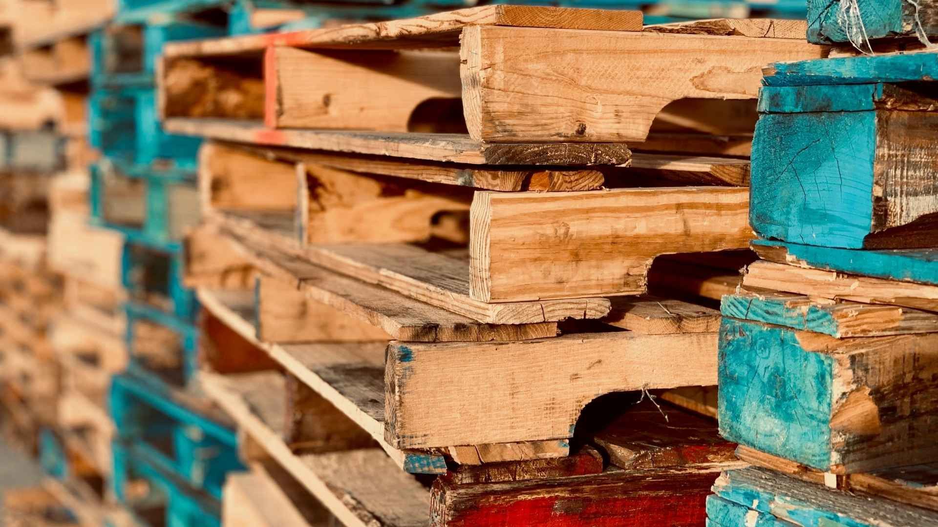A pile of wooden pallets stacked on top of each other.