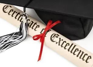 A rolled Certificate of Excellence with a red ribbon rests beside a black graduation cap with a tassel.