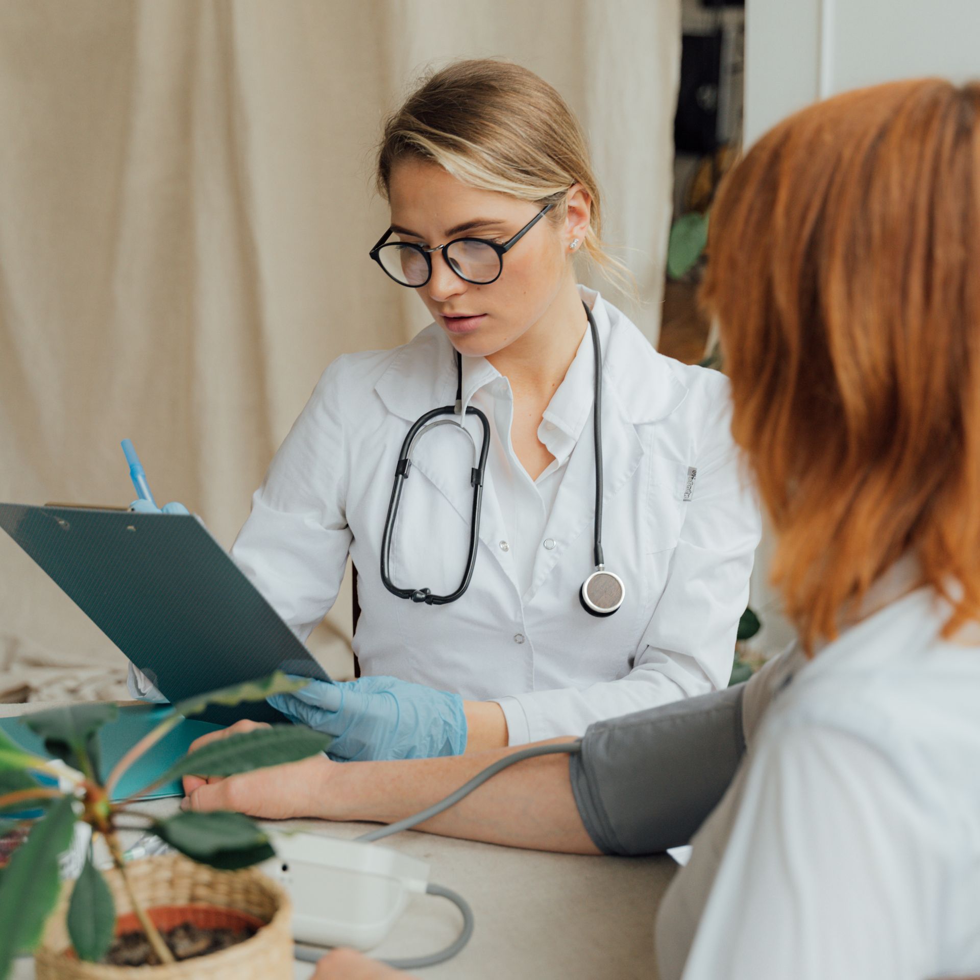 a man is getting a nasal swab from a doctor .