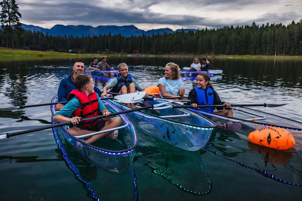 Guests enjoying a clear kayak on a Montana lake
