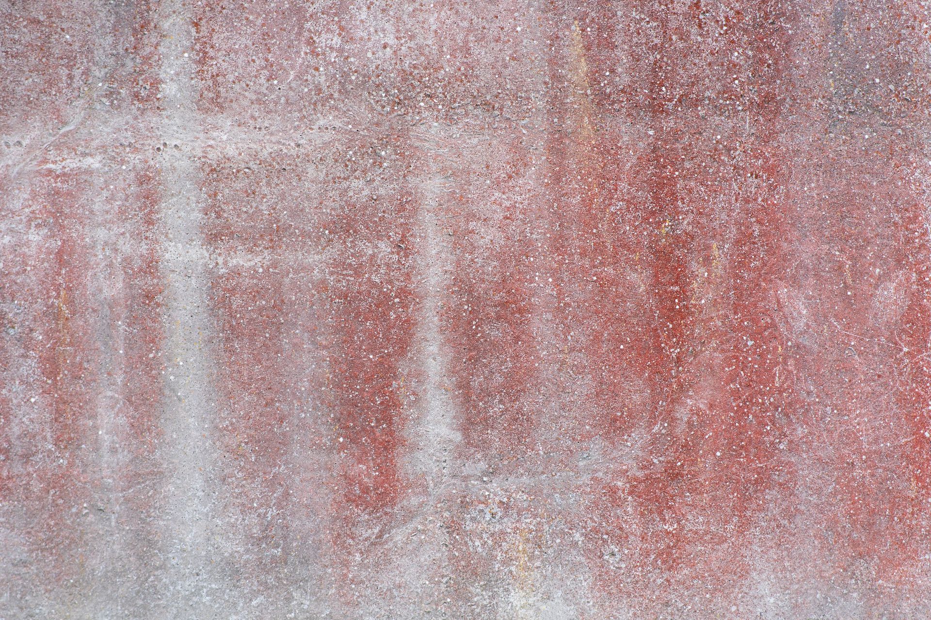 Abstract red and white textured surface with vertical brush-like streaks