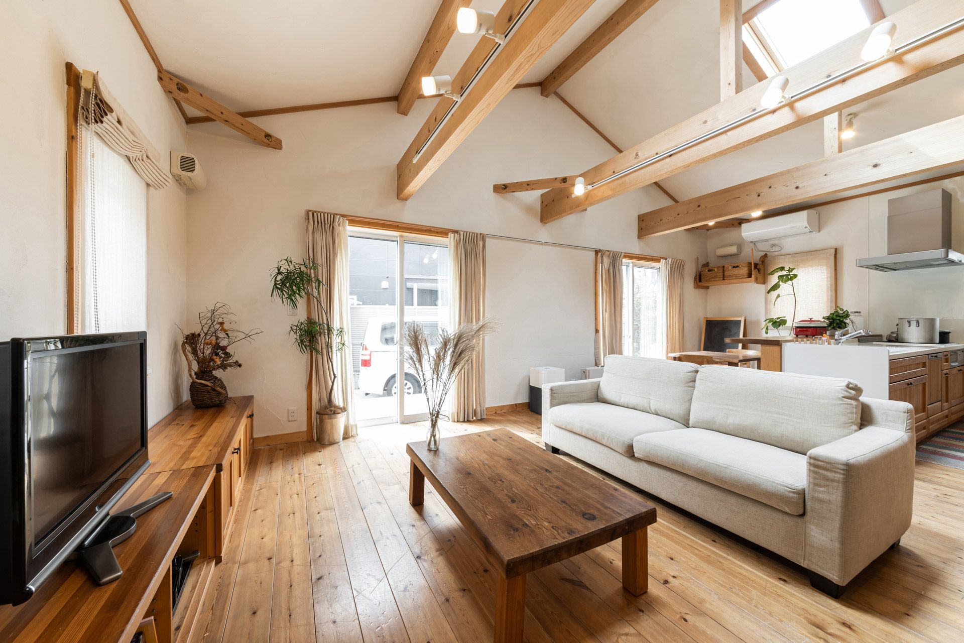 A living room with a couch , table , and television.
