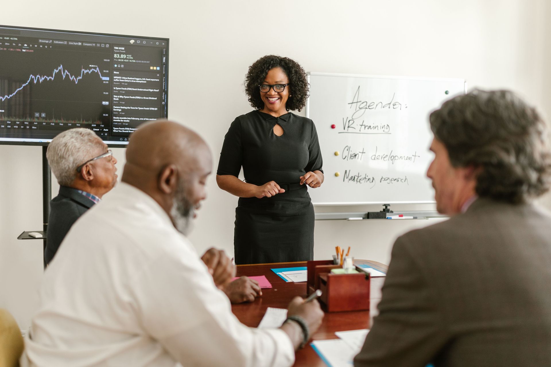 Facilitator at a whiteboard leads new community association board members through an orientation