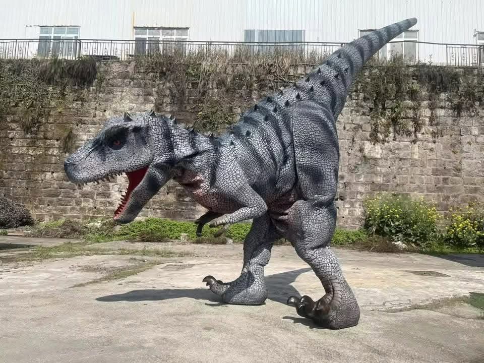 Gray striped T. rex statue roaring in an outdoor courtyard against a stone wall