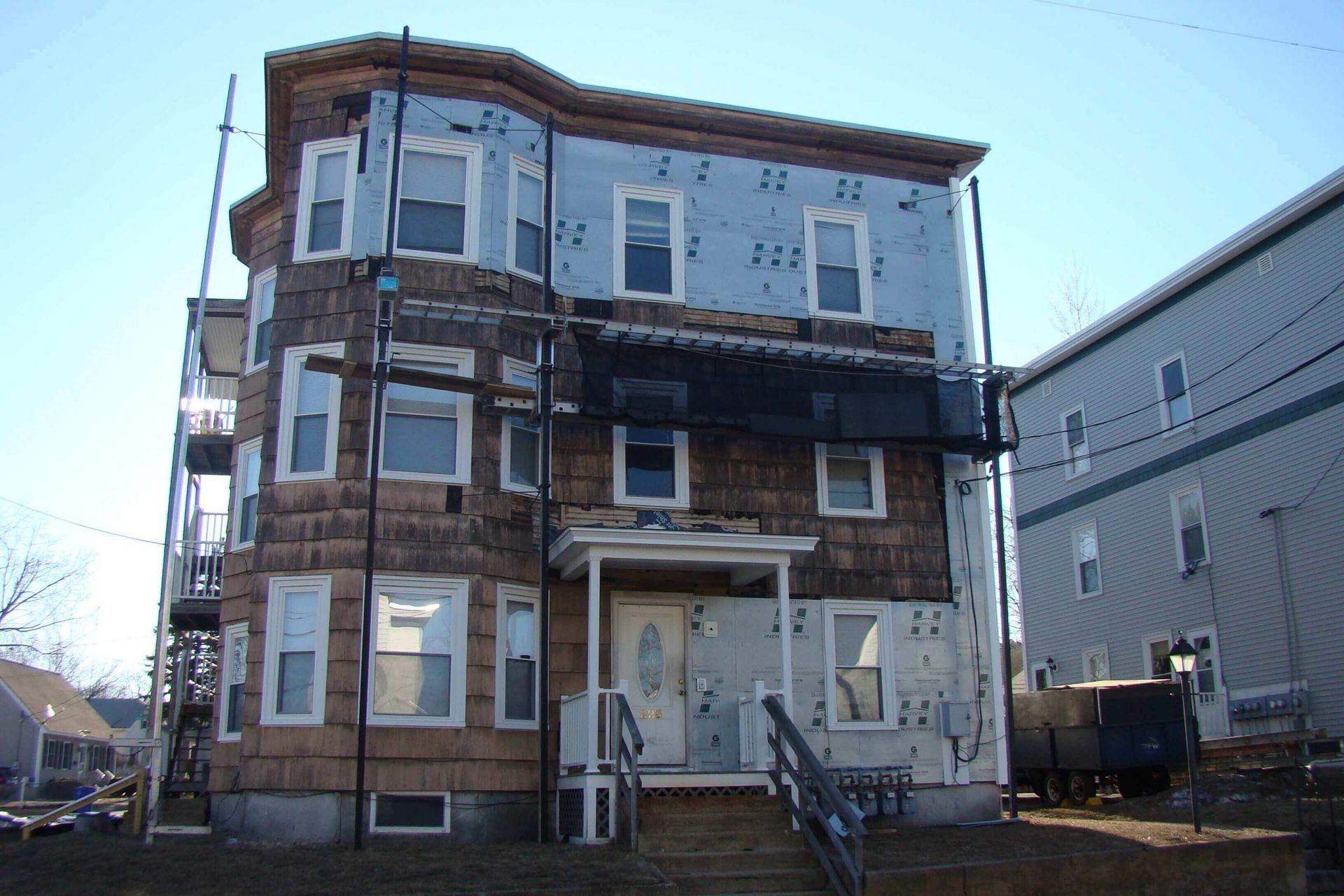 A building with a lot of windows is being remodeled