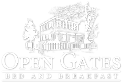 Open Gates Bed and Breakfast logo with a house and trees in soft gray line art