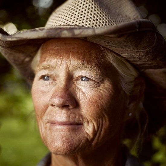 A close up of a woman wearing a cowboy hat