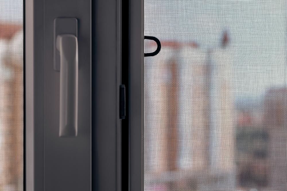 A close up of security screen on sliding door — Grainger Windows & Doors in Lennox Head, NSW