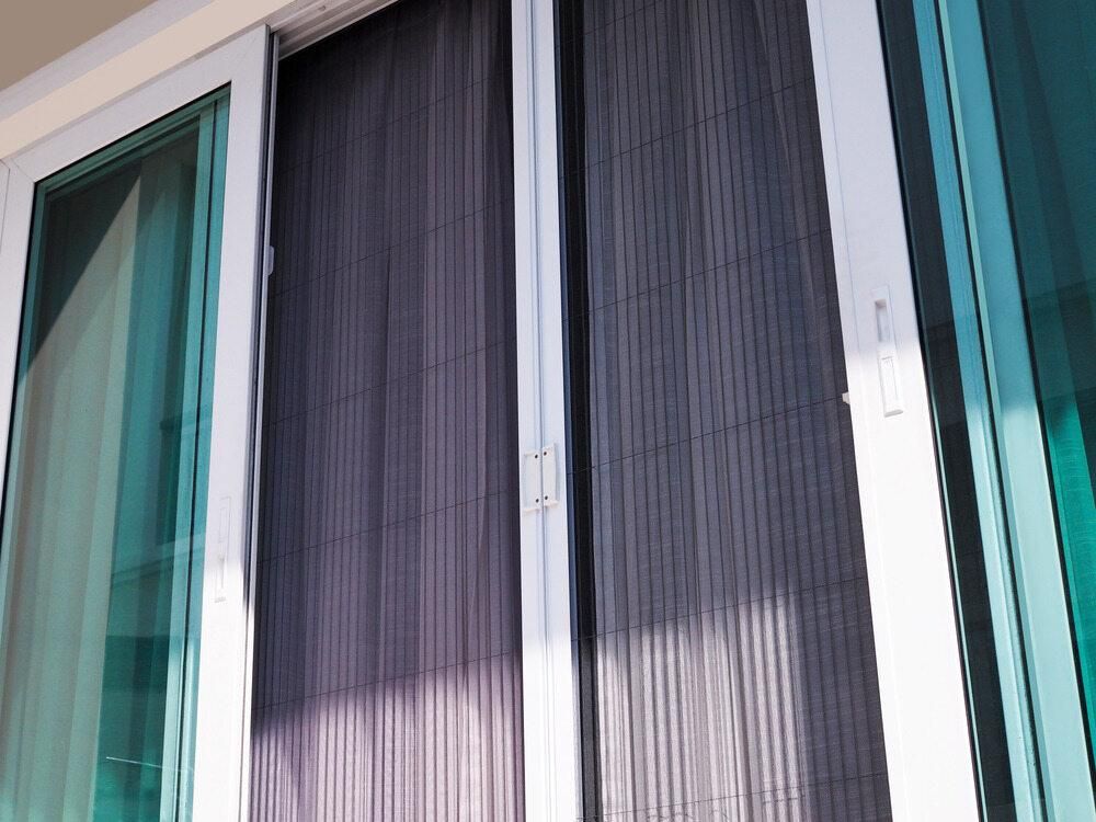 A Close up Of a Sliding Glass Door with A Screen on It — Grainger Windows & Doors in Ballina, NSW