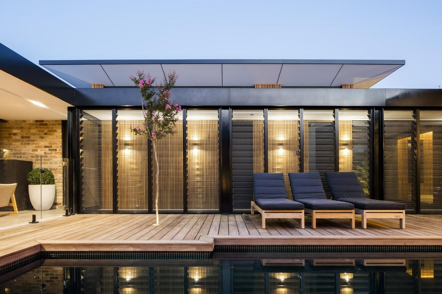 A House with A Swimming Pool in Front of It — Grainger Windows & Doors in Wardell, NSW