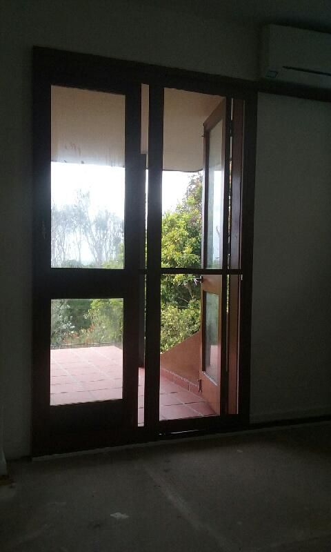 A Room with A Sliding Glass Door Leading to A Balcony — Grainger Windows & Doors in Ballina, NSW