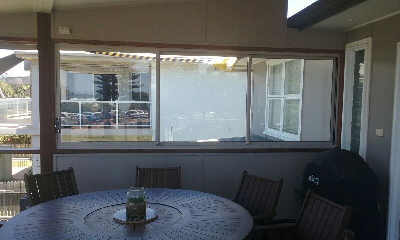 A Table and Chairs in A Room with A Large Window — Grainger Windows & Doors in Ballina, NSW