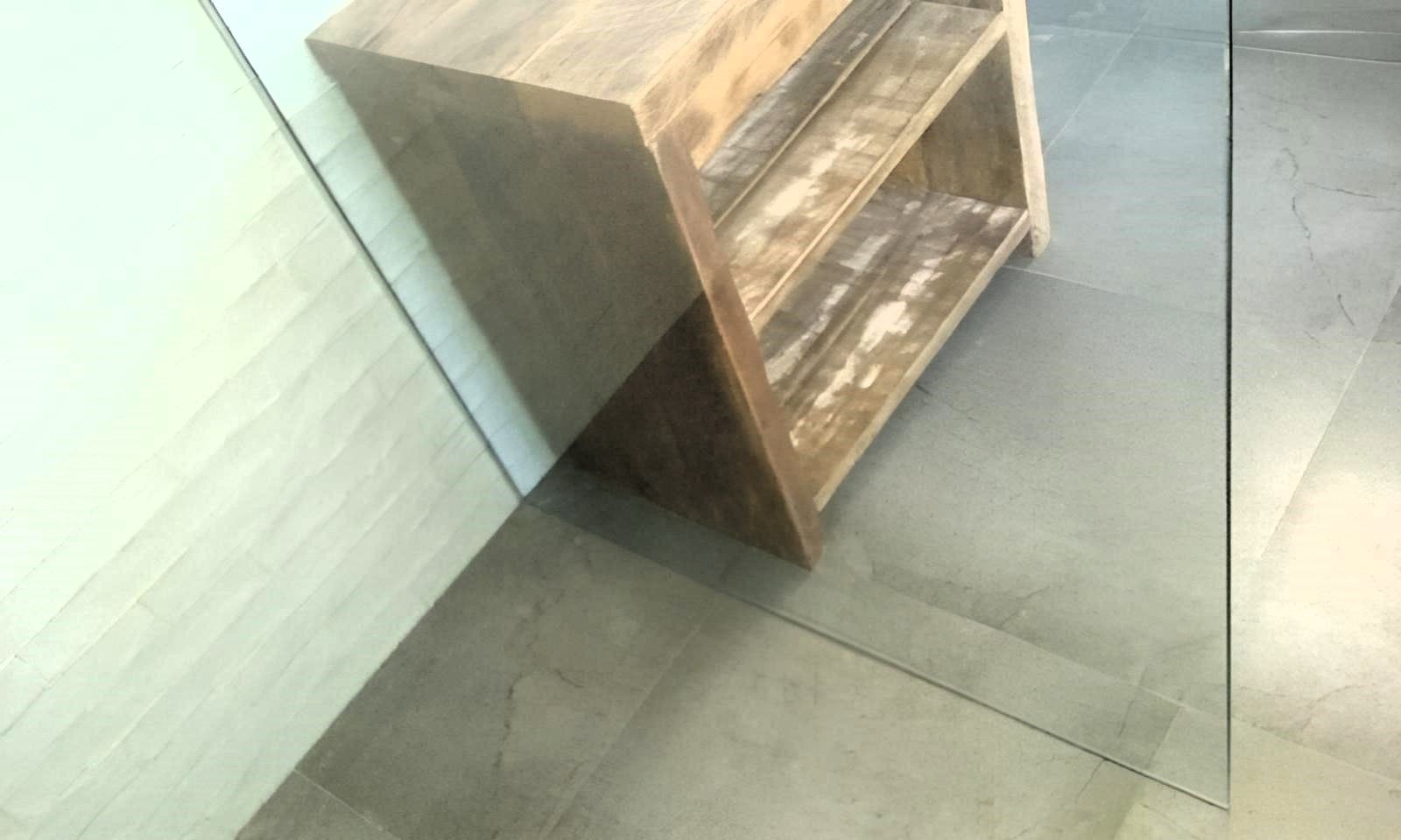 A Wooden Shelf Is Sitting on A Tiled Floor Next to A Glass Wall — Grainger Windows & Doors in Wollongbar, NSW