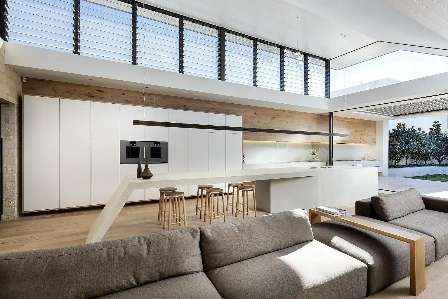 A Large lounge and dining area with Louvre windows below ceiling — Grainger Windows & Doors in Ballina, NSW