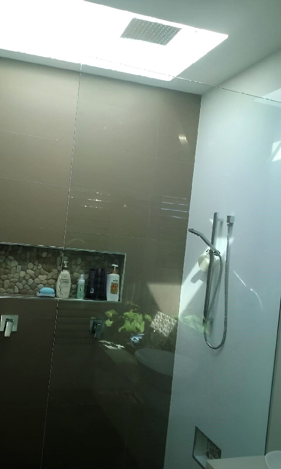 A Bathroom with A Shower, Toilet and A Shelf — Grainger Windows & Doors in Wollongbar, NSW
