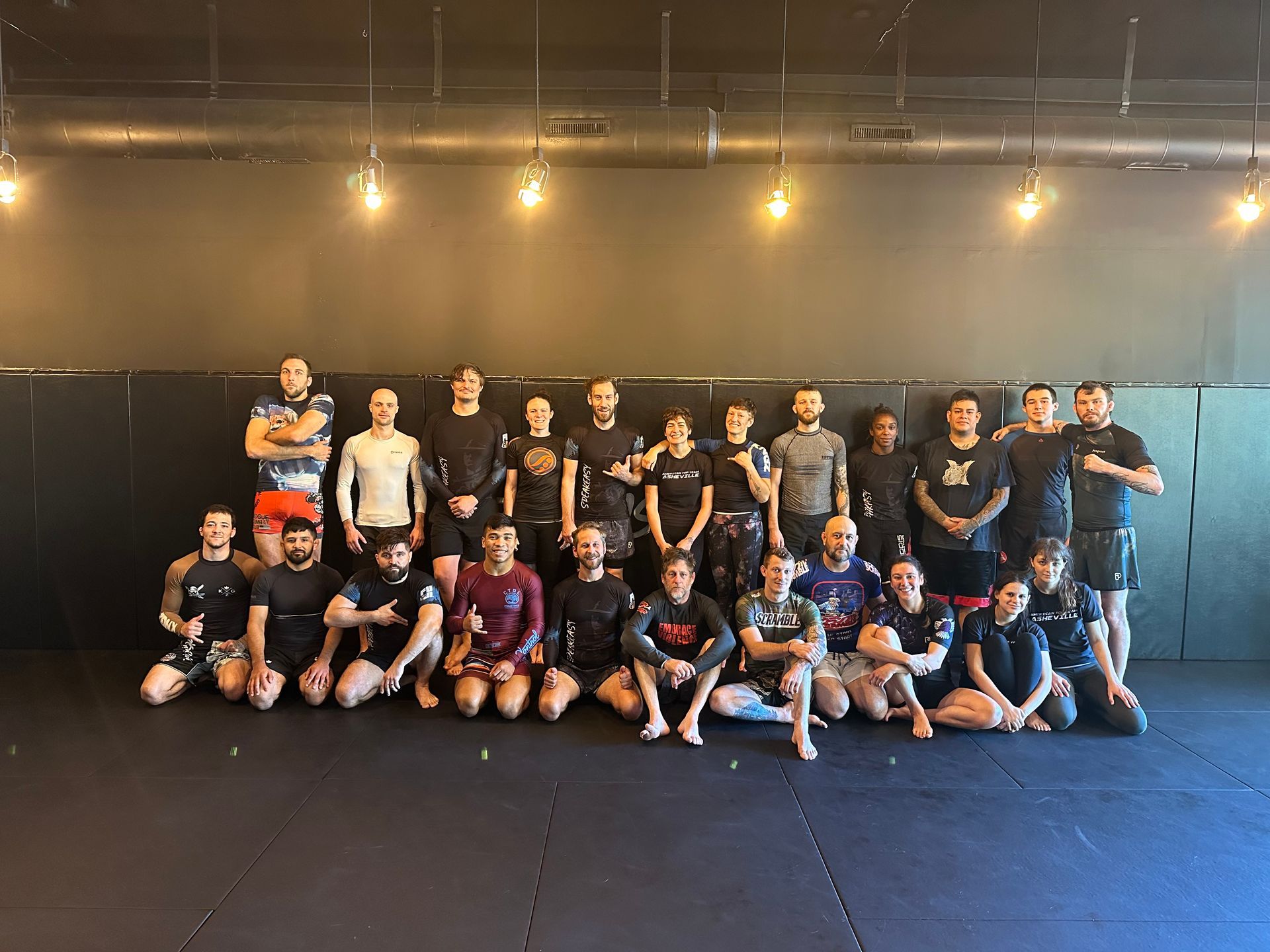 Adults drilling grappling techniques at Speakeasy Jiu-Jitsu & Wrestling Academy in Asheville, NC for strength and community.