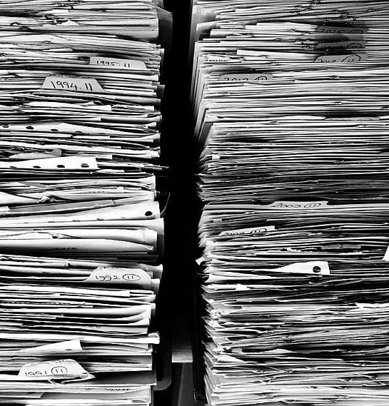 A black and white photo of two stacks of papers.