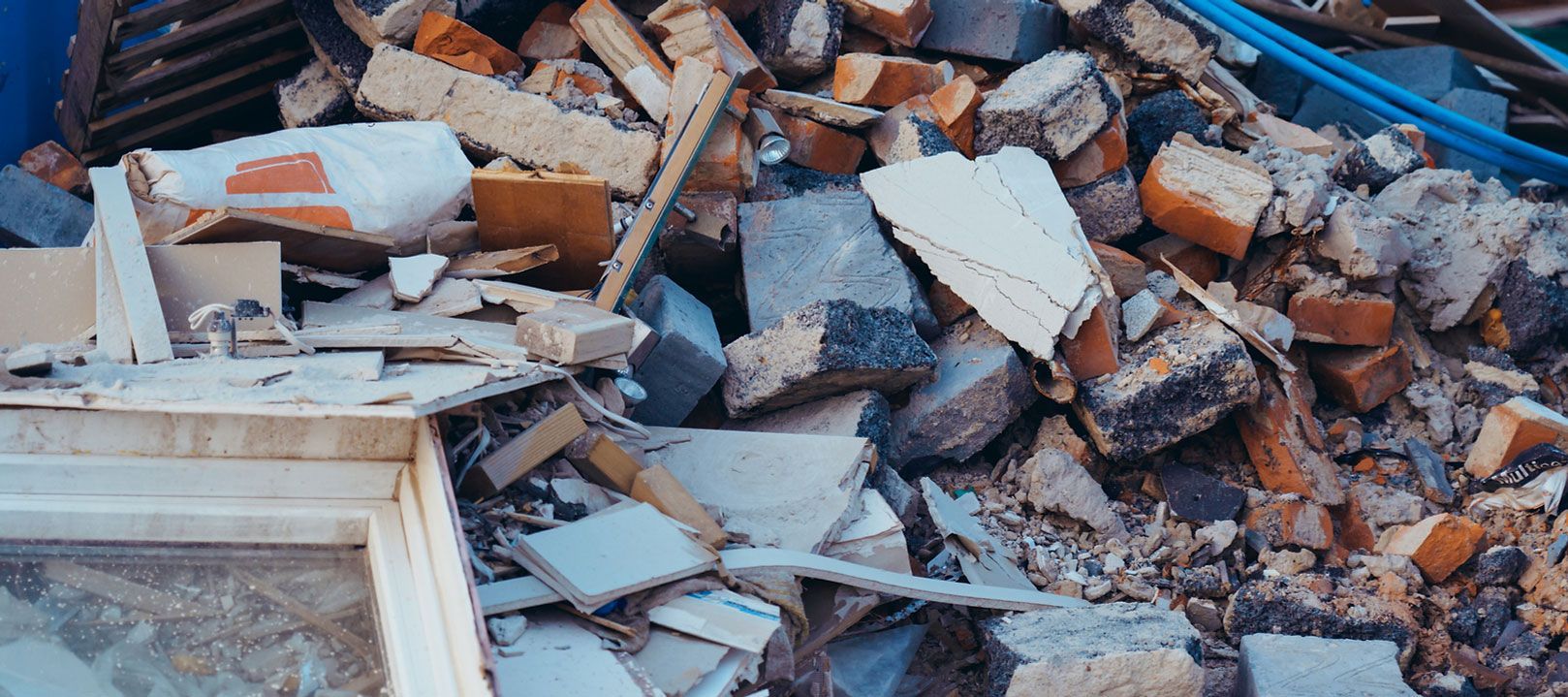 Pile of rubble, bricks, and debris from a building collapse.