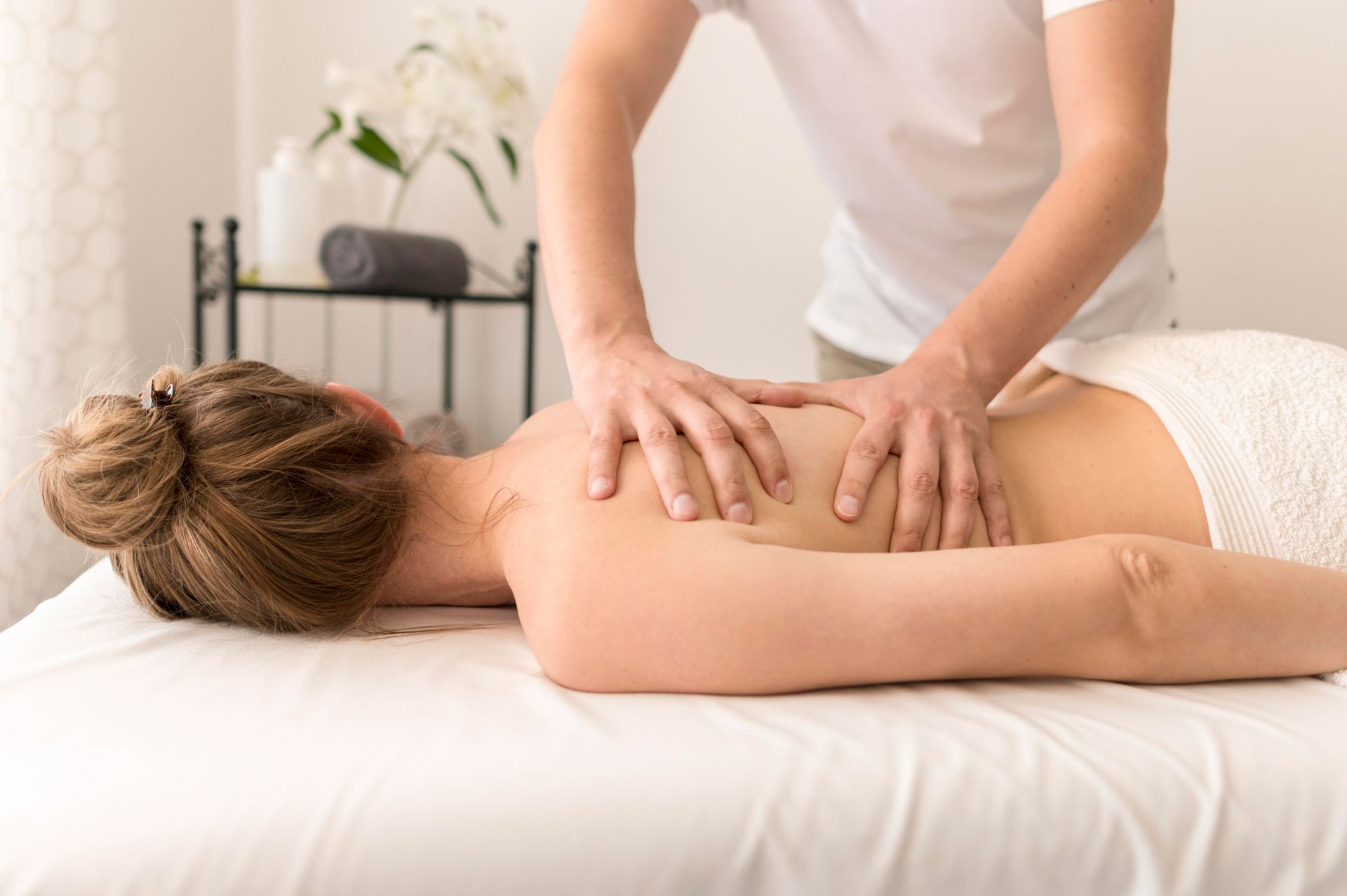 a woman is laying on a massage table getting a massage .