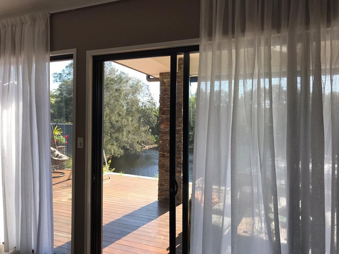 Curtains in Ballina featuring elegant sheer curtains fitted to sliding glass doors for privacy, light filtering and modern style.