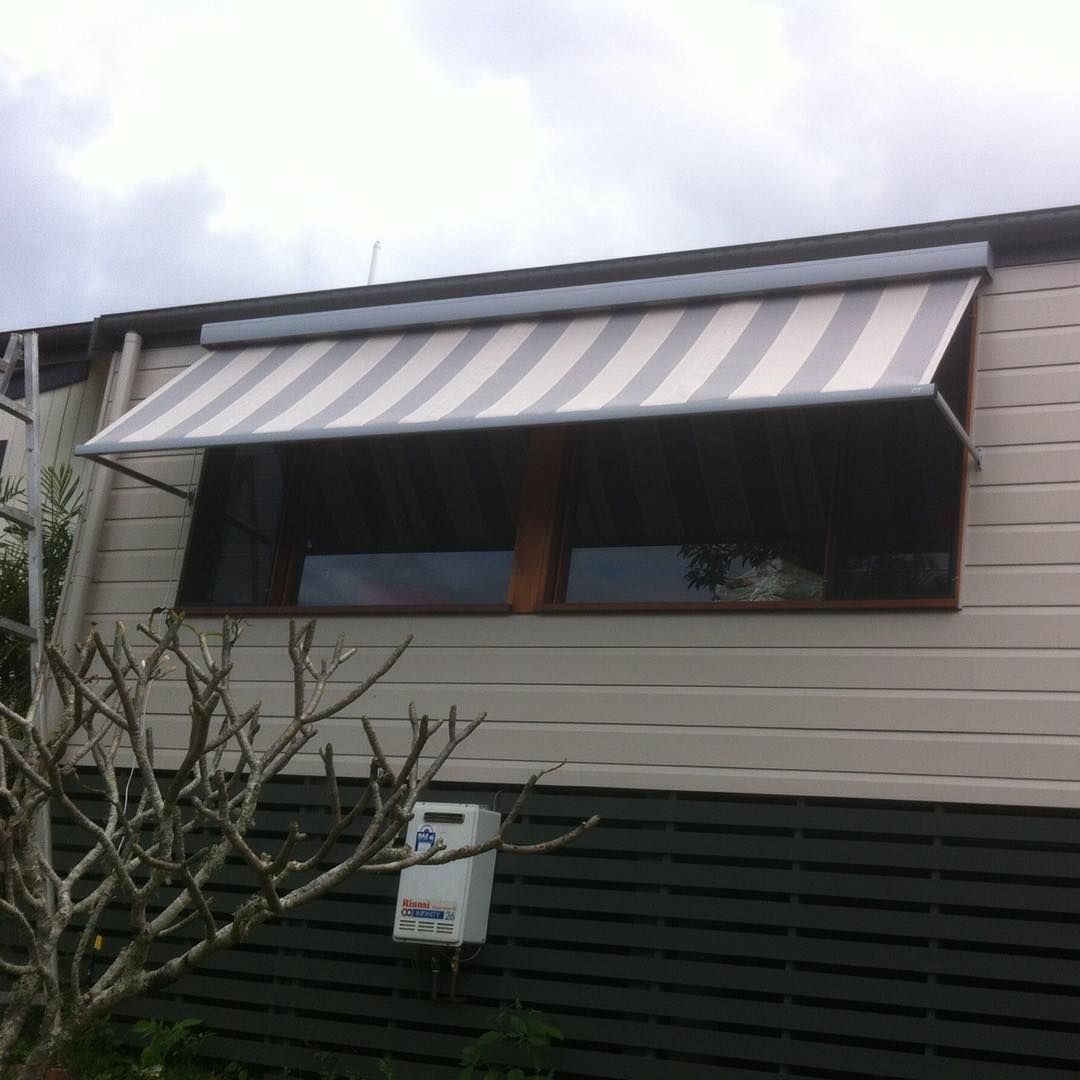 Gray and White Striped Awning Over a Window on a Light-coloured Building — BlindDESIGN in Tweed Heads, NSW