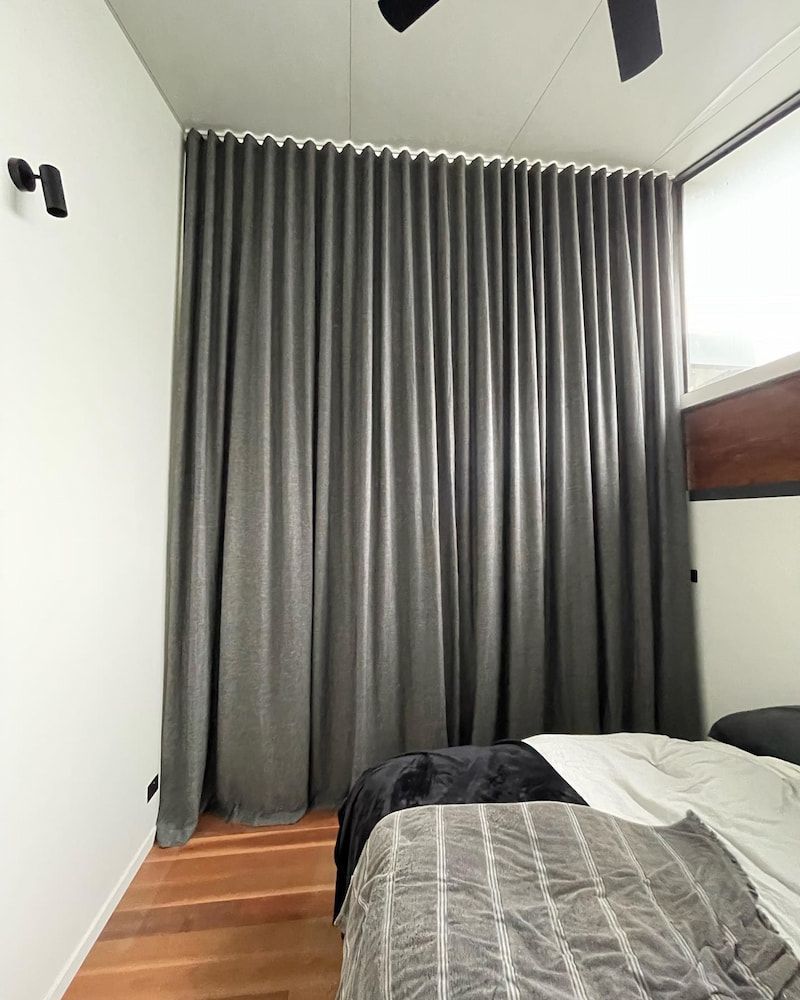 Gray Curtains Cover a Wall, in a Bedroom — BlindDESIGN in Mullumbimby, NSW