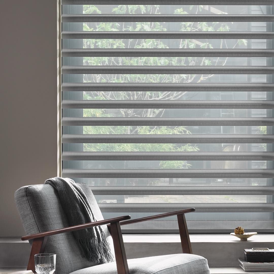 Gray Window Blinds Behind an Armchair — BlindDESIGN in Byron Bay, NSW