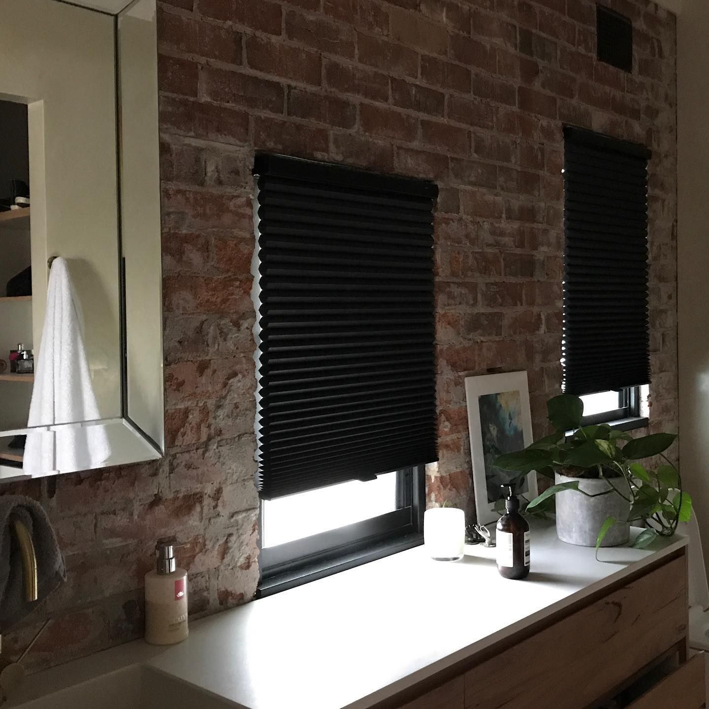 Bathroom With Exposed Brick Wall, Black Blinds, and a Vanity — BlindDESIGN in Tweed Heads, NSW