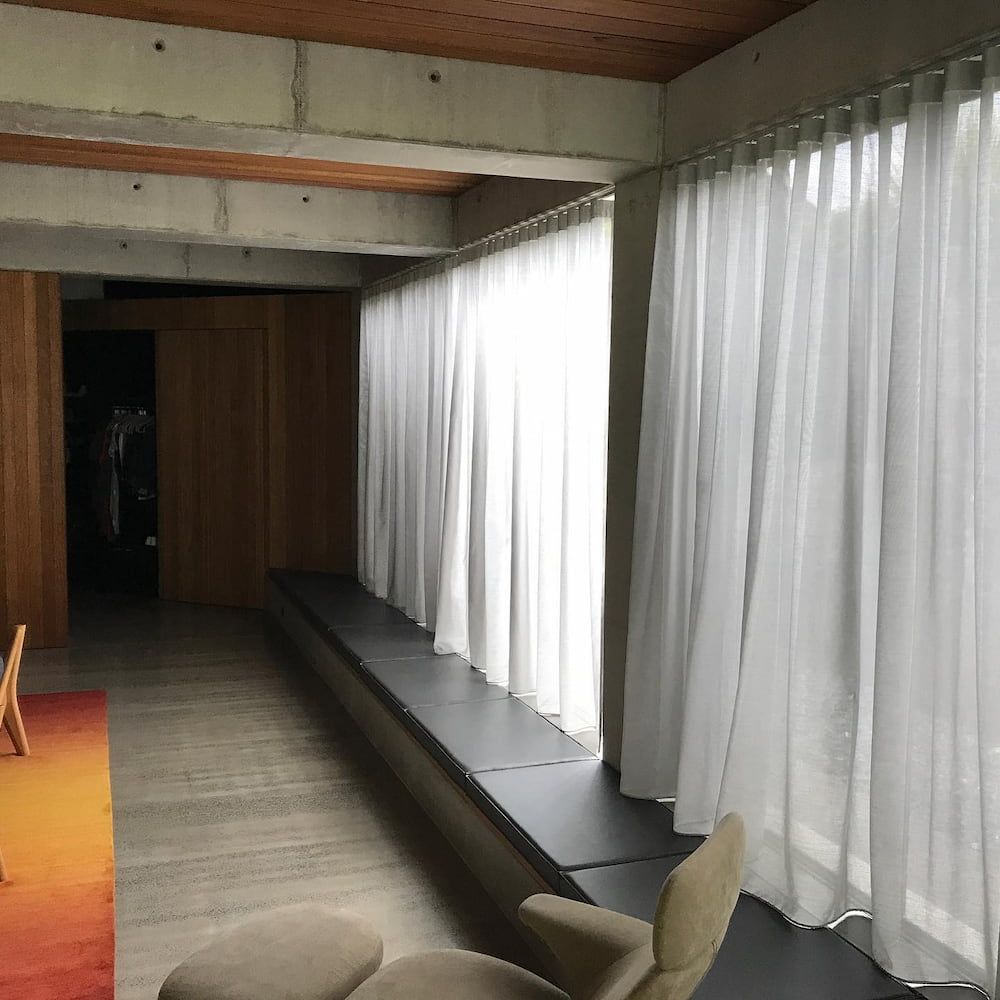 Interior View of a Modern Room With White Curtains, a Long Window Seat — BlindDESIGN in Mullumbimby, NSW