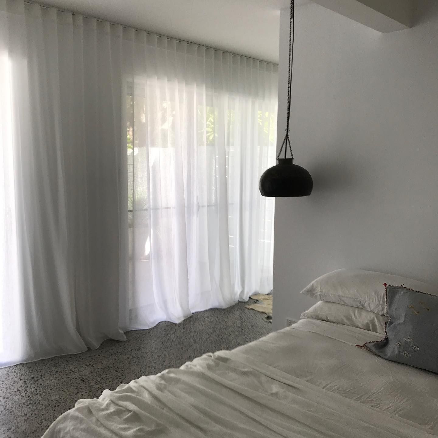Bedroom With Sheer White Curtains, a Bed, and a Black Hanging Light — BlindDESIGN in Byron Bay, NSW