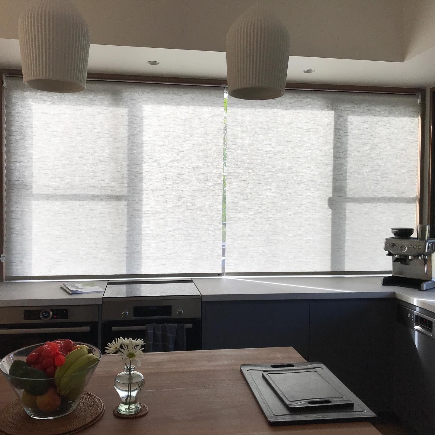 Custom white blinds in Ballina featuring light-filtering roller blinds installed in a modern kitchen for privacy and natural light control.