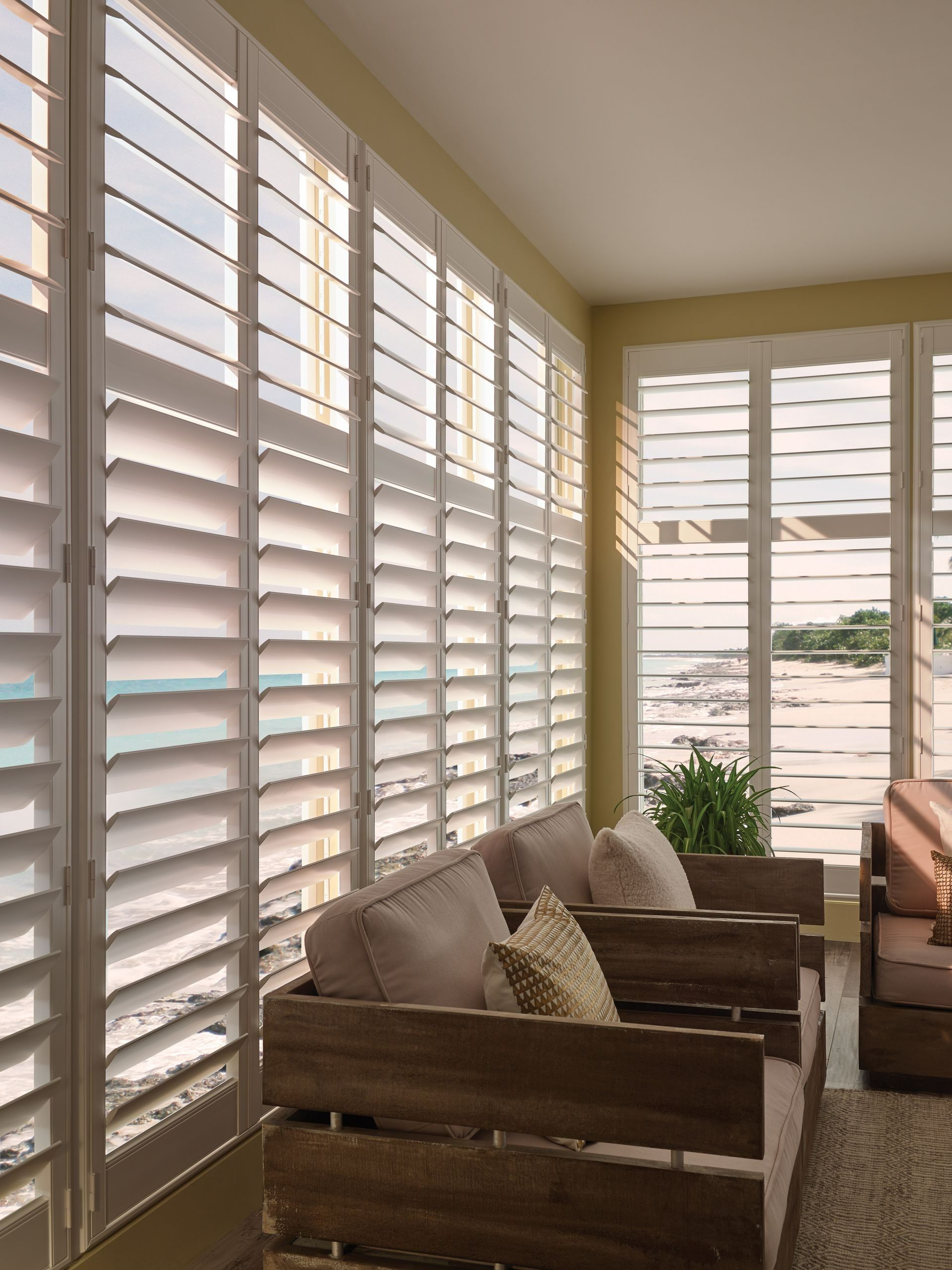 Living Room with White Shutters, Two Armchairs, and A Window View of The Beach — BlindDESIGN in Lismore, NSW
