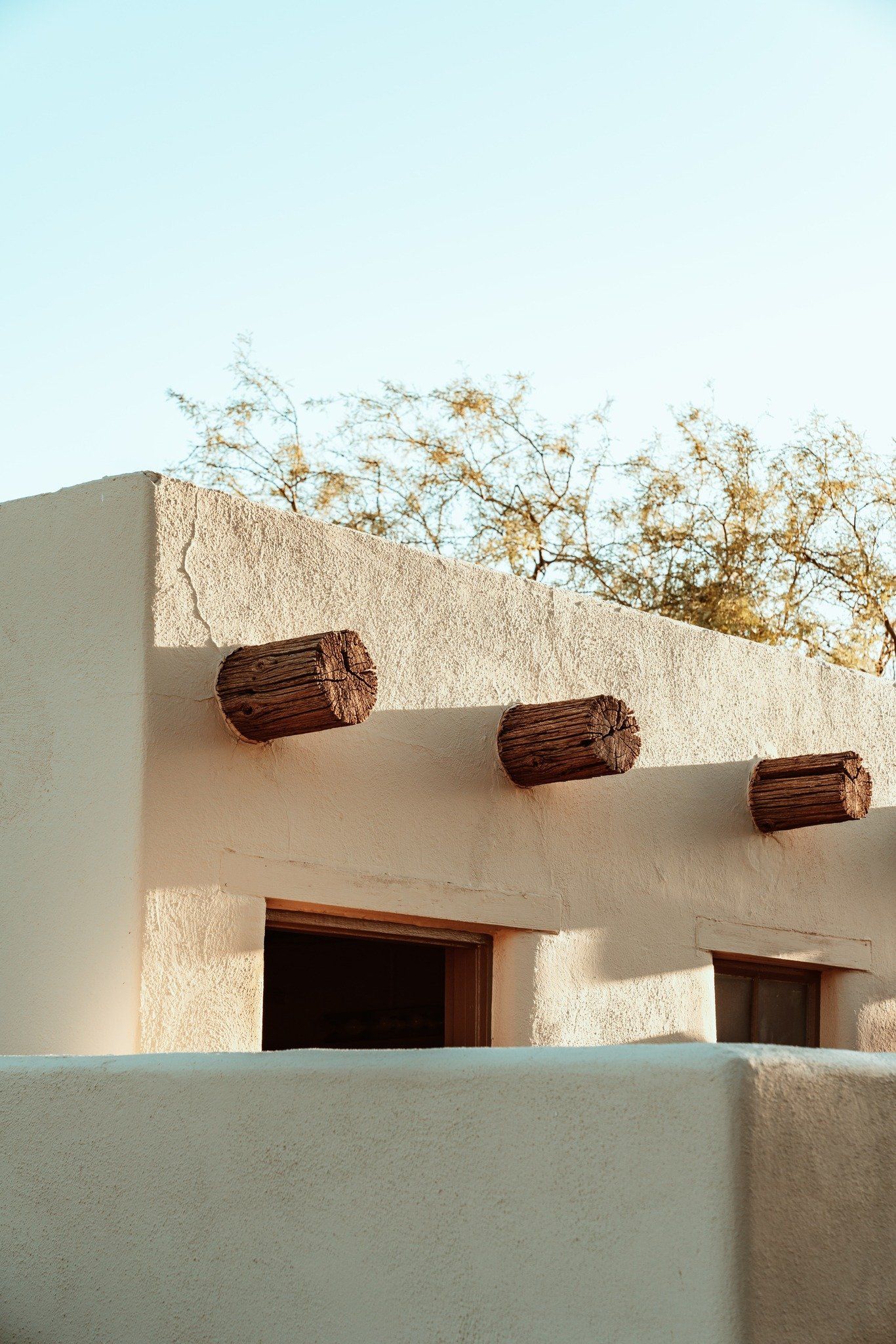 A white building with wooden beams on the side of it.