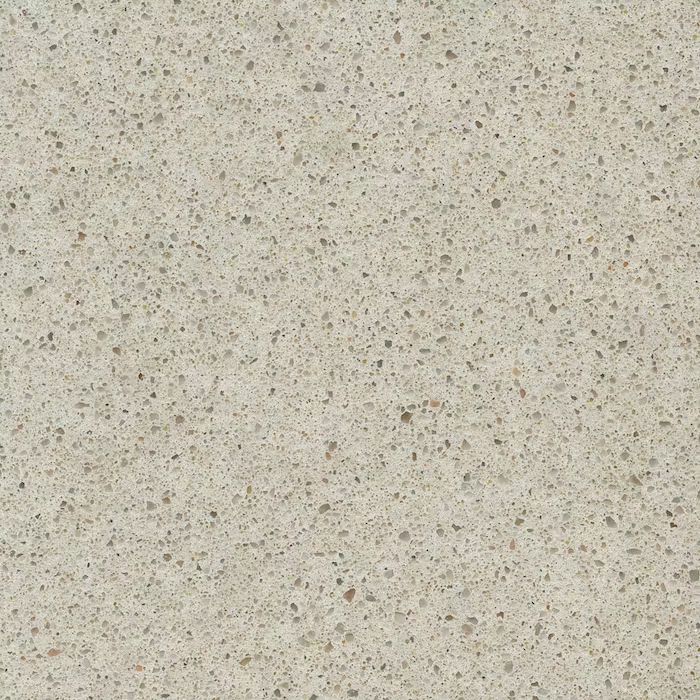 Un primer plano de un azulejo blanco con pequeños puntos.
