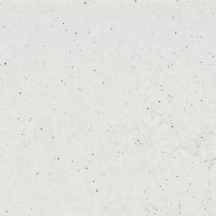 Un primer plano de una superficie blanca con pequeños puntos.