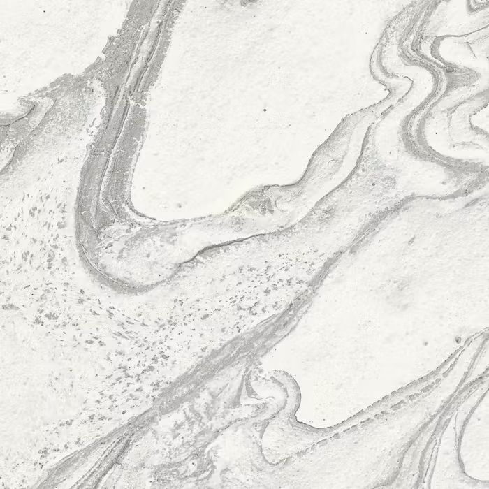 Un primer plano de una textura de mármol blanco sobre una superficie blanca.