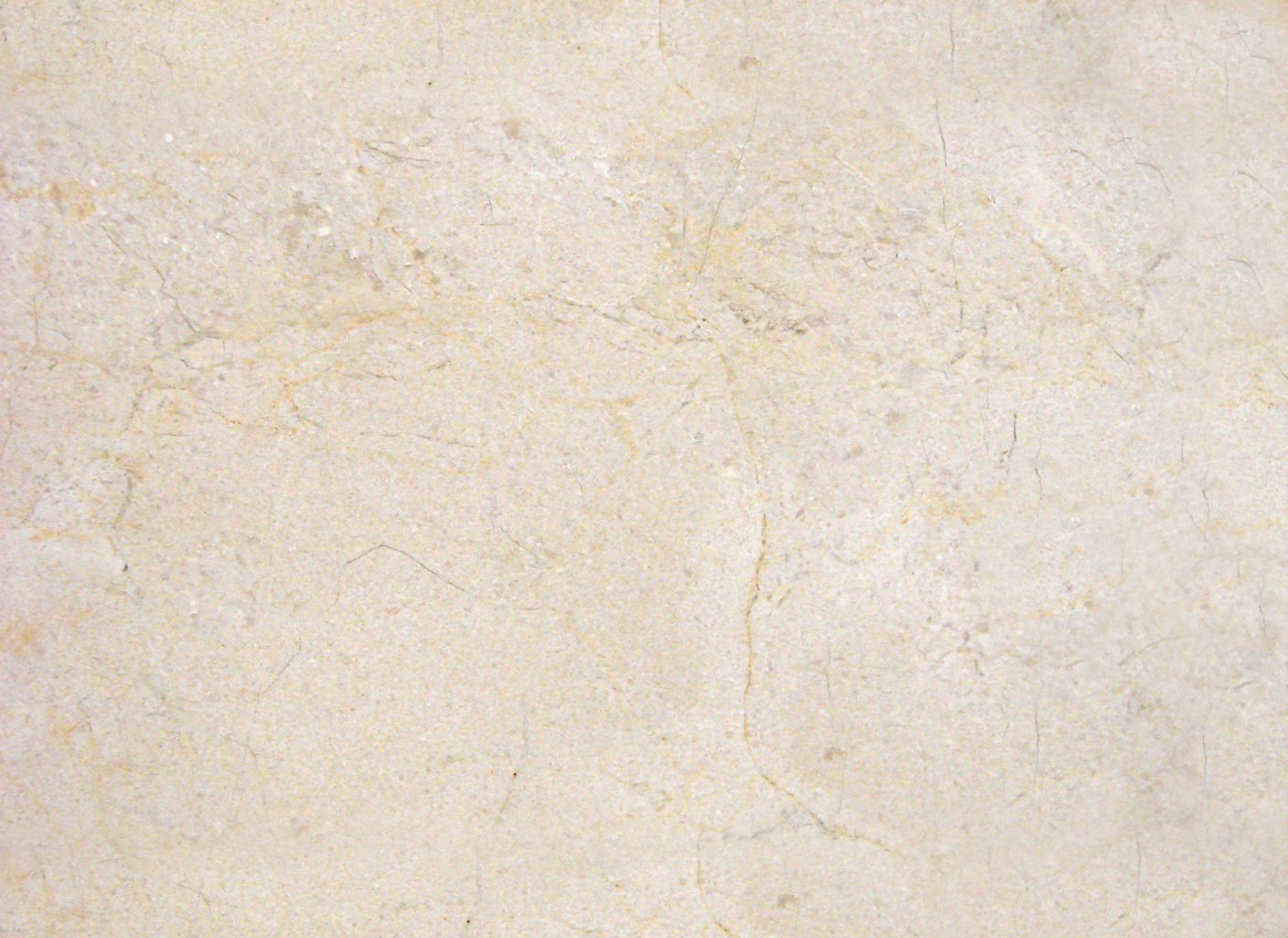 Un primer plano de un azulejo beige con textura de mármol.