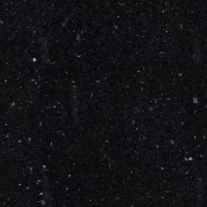 Un primer plano de una encimera de granito negro con manchas blancas.