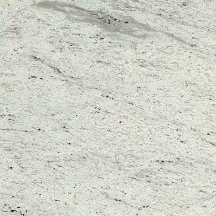 Un primer plano de una encimera de granito blanco.