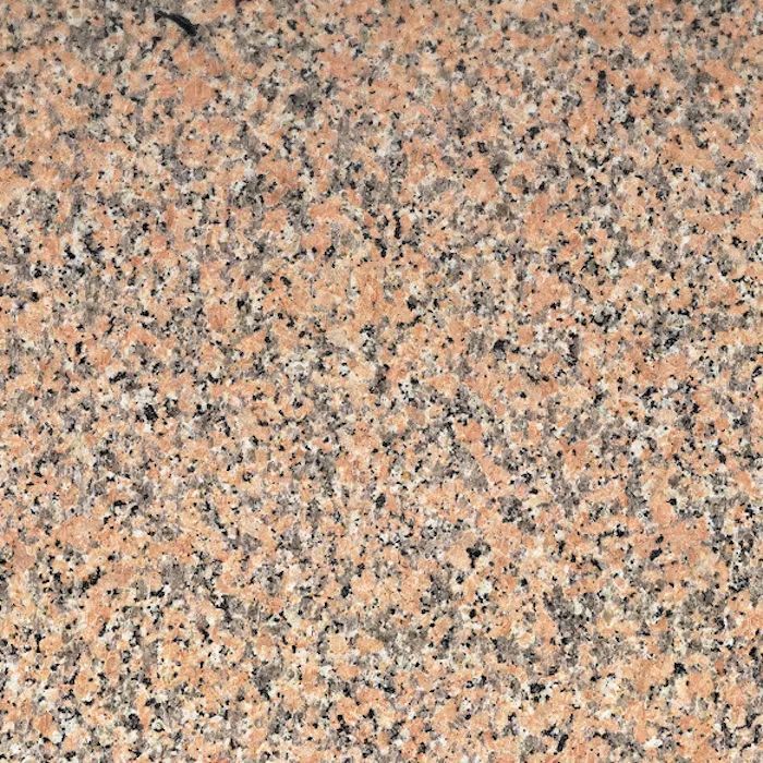 Un primer plano de una encimera de granito rosa