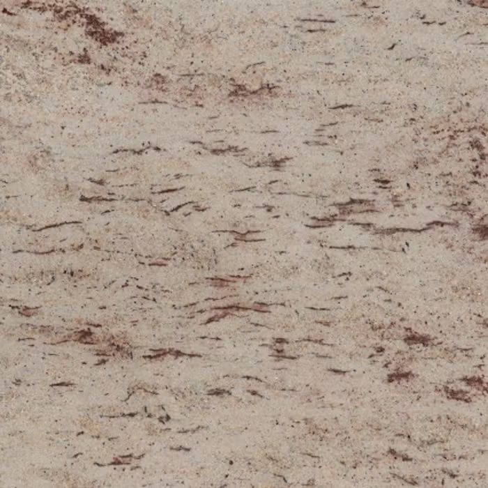 Un primer plano de una encimera de granito blanco con manchas marrones