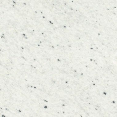 Un primer plano de una superficie blanca con manchas negras.