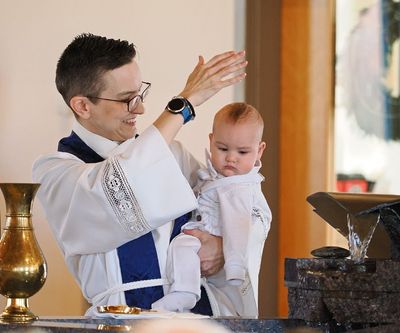 Pastor Karen baptizing a baby