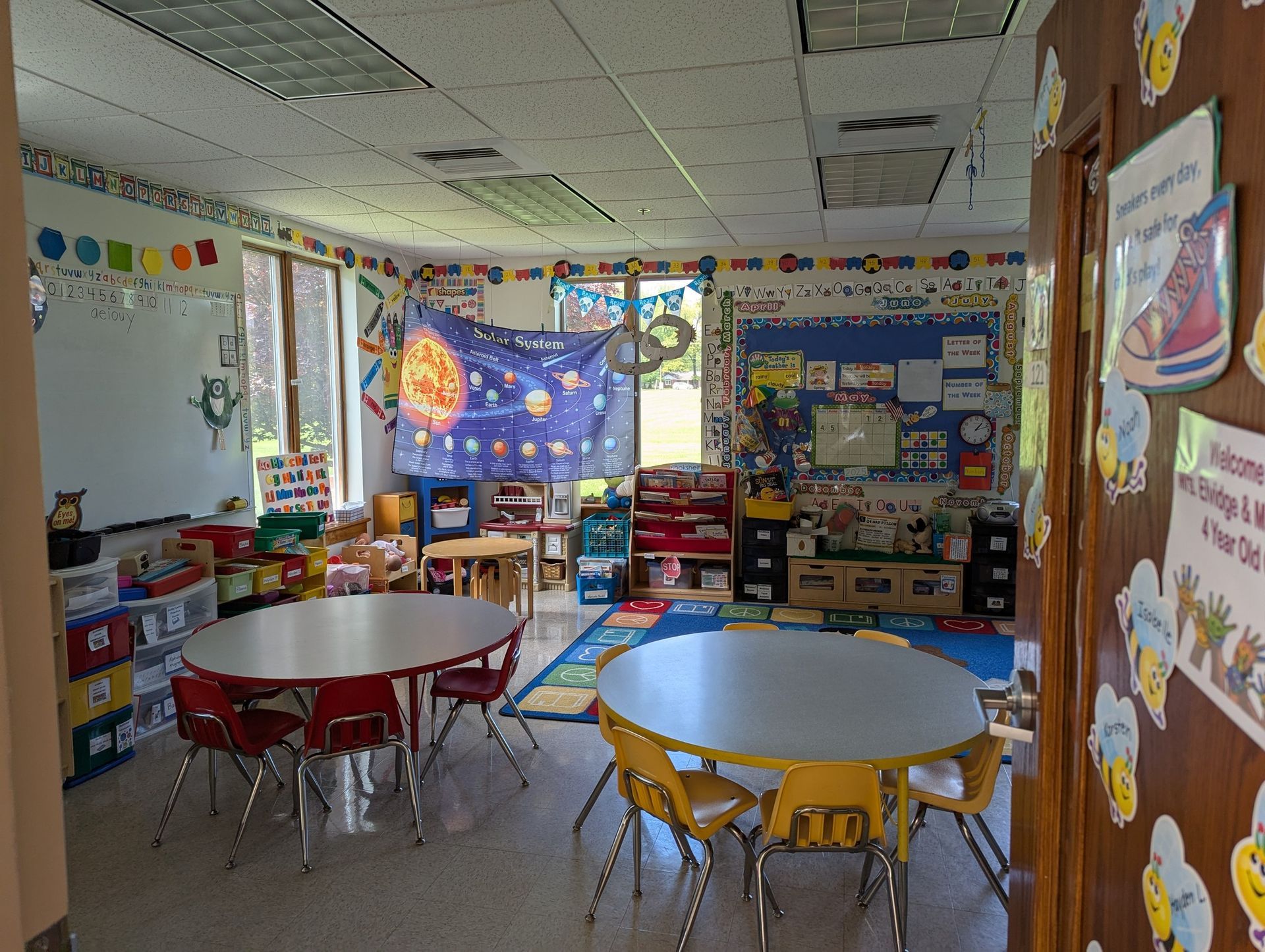 A classroom with tables and chairs in it