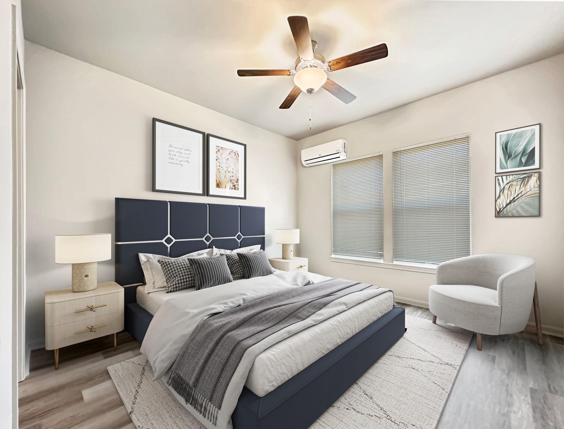 Modern bedroom with navy bed, gray bedding, white walls, ceiling fan, and a window bench seat.