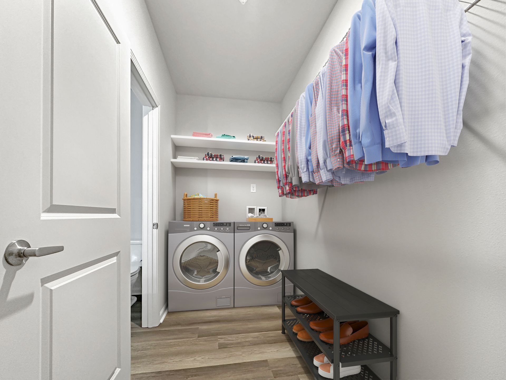 Narrow laundry room with washer and dryer, hanging clothes, shelves, and storage bench