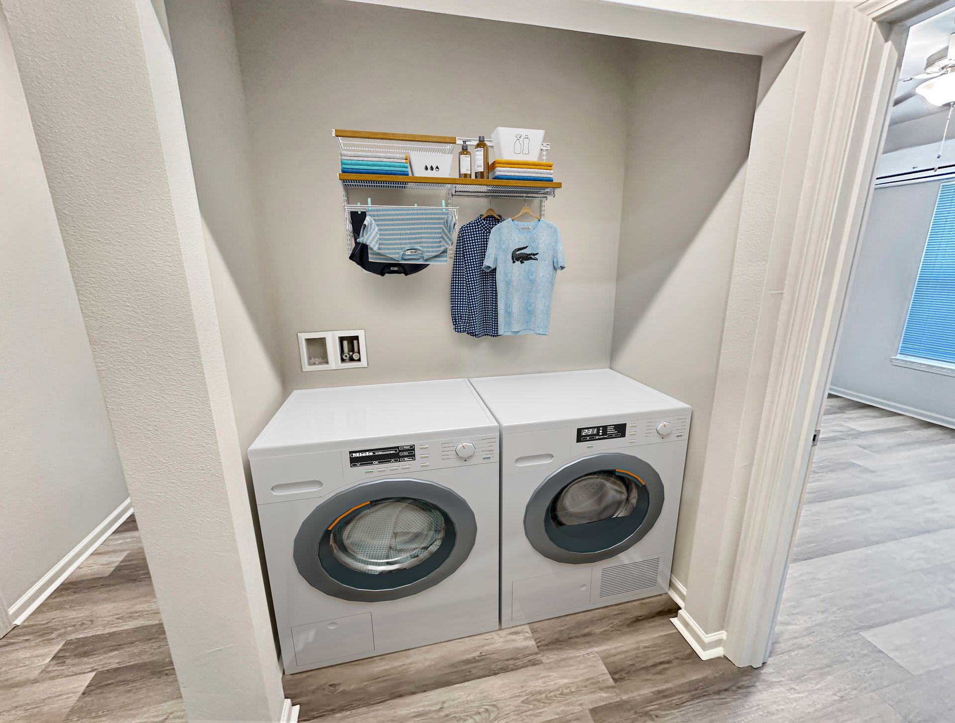 Laundry nook with stacked shelves, front-load washer and dryer, and hanging cleaning items in a closet alcove