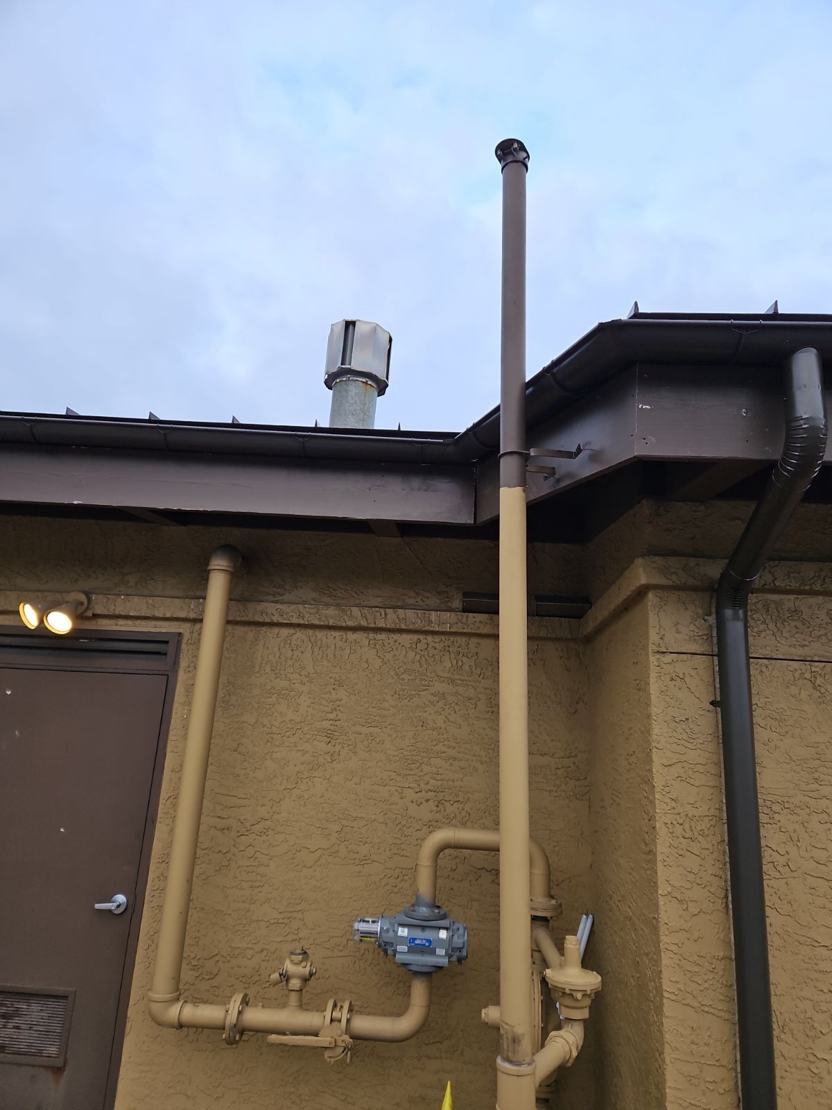 A Large Pipe is Attached to the Side of a Building – Lititz, PA – Trailside Spouting, LLC