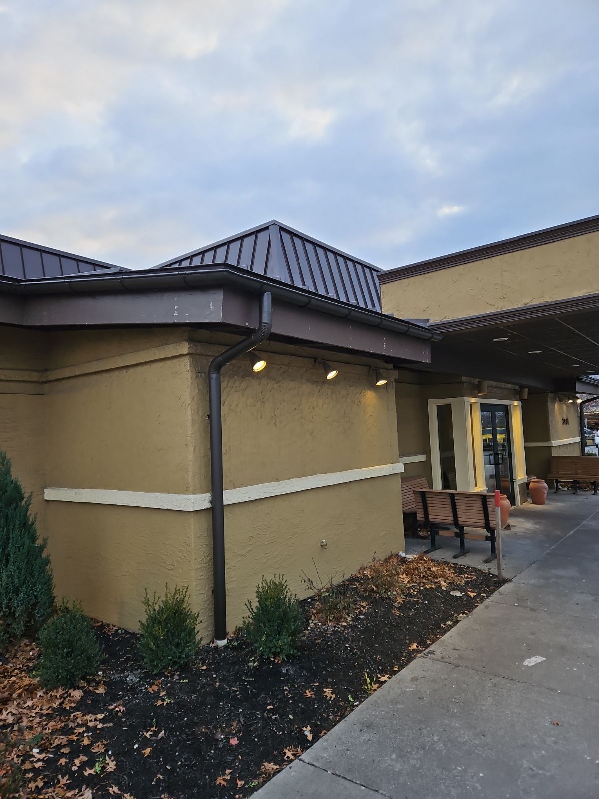 A Large Building with a Roof and a Bench in Front of it – Lititz, PA – Trailside Spouting, LLC